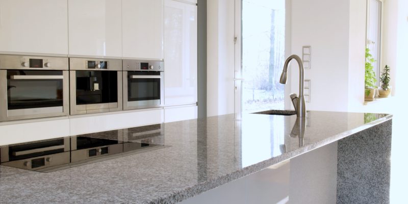 Minimalist modern kitchen with buil-in appliances and induction hob